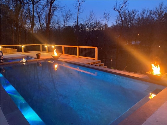 view of pool with a fenced in pool and an outdoor fire pit