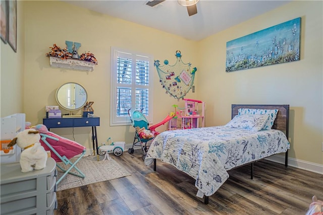 bedroom with a ceiling fan, visible vents, wood finished floors, and baseboards