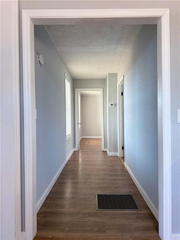 hallway with dark hardwood / wood-style flooring