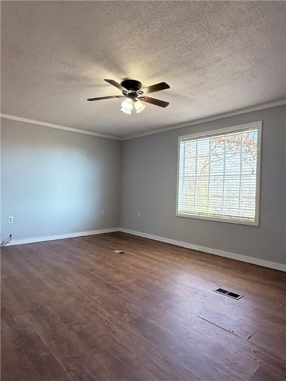 spare room with ceiling fan, a textured ceiling, dark hardwood / wood-style flooring, and crown molding