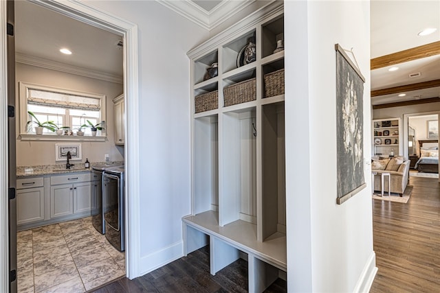 mudroom with dark wood-style floors, washer and dryer, crown molding, and recessed lighting