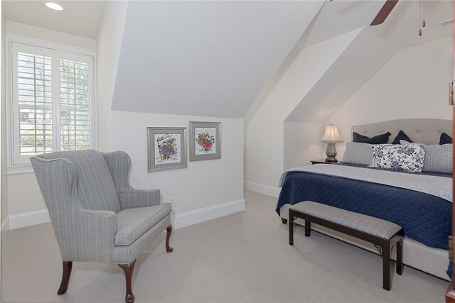 bedroom featuring carpet, vaulted ceiling, multiple windows, and ceiling fan