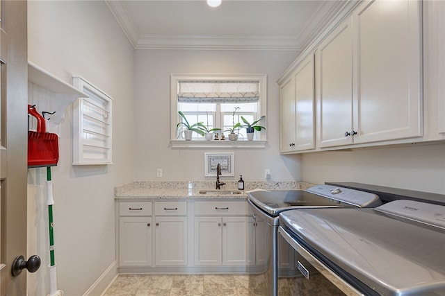 laundry room with cabinet space, ornamental molding, a sink, separate washer and dryer, and baseboards