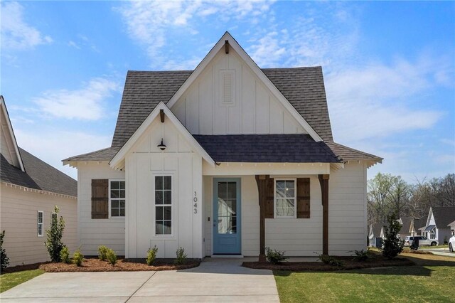 modern farmhouse style home with a front yard