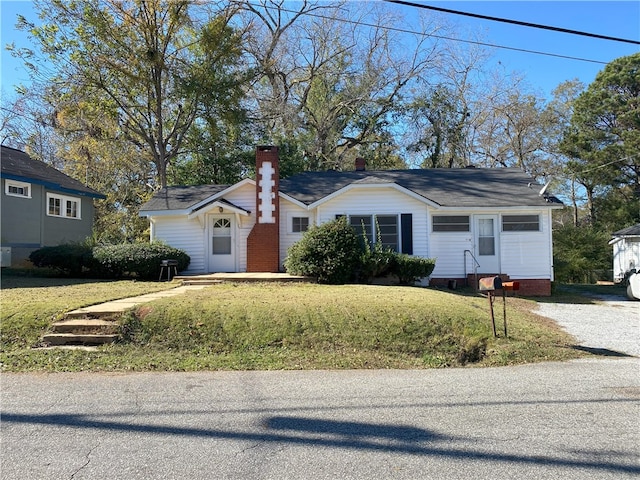 ranch-style home with a front lawn