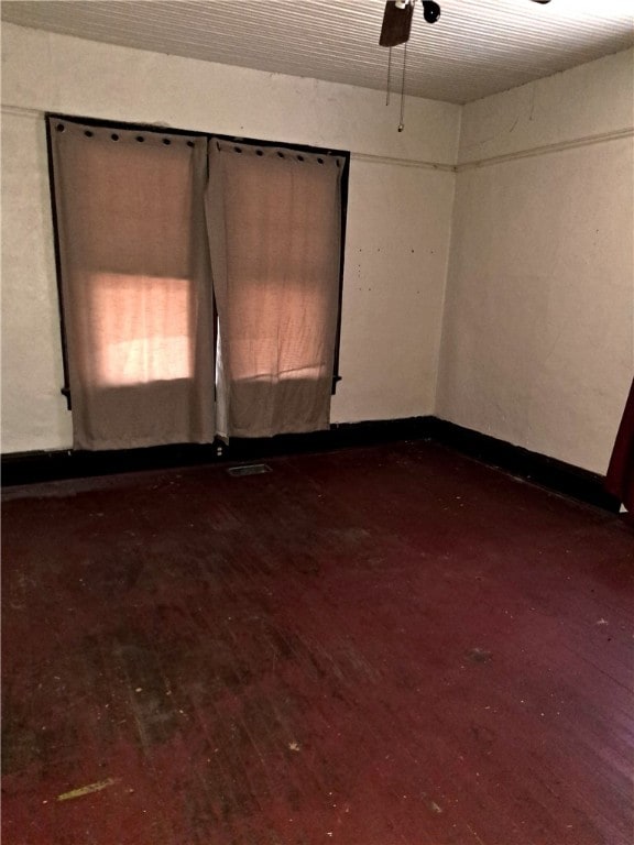 unfurnished room featuring dark wood-style floors