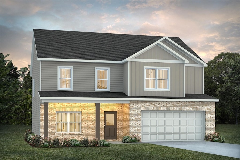 view of front of home featuring a garage and a yard