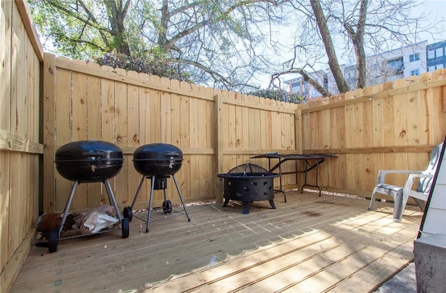 deck featuring area for grilling and fence