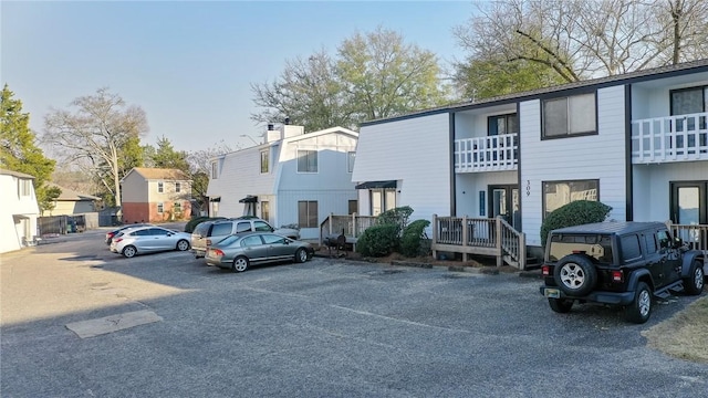 uncovered parking lot featuring a residential view