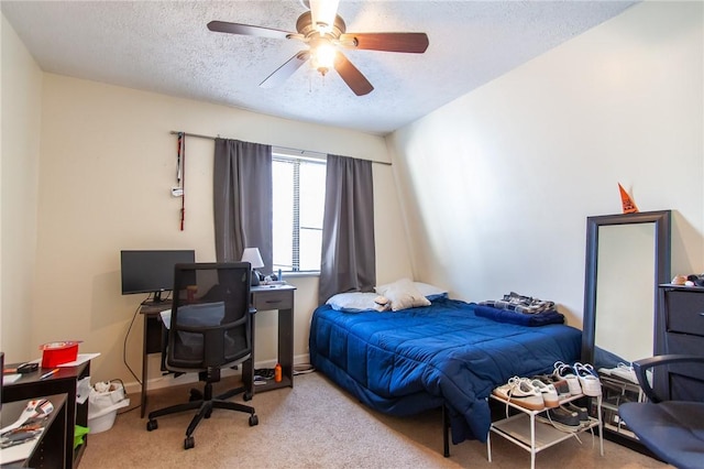 bedroom featuring baseboards, carpet, a ceiling fan, and a textured ceiling