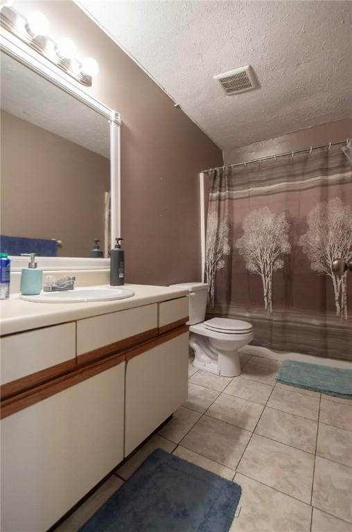 bathroom with visible vents, toilet, a textured ceiling, vanity, and tile patterned floors