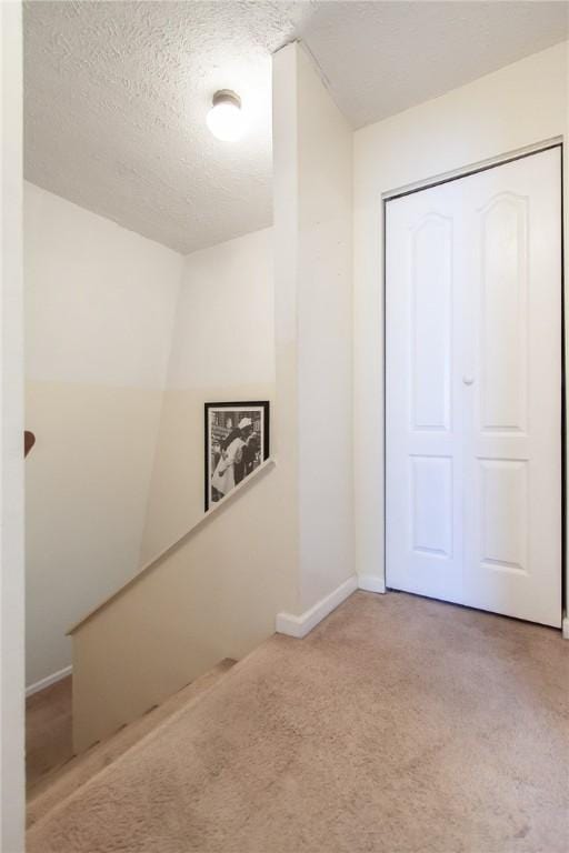 interior space with baseboards and a textured ceiling