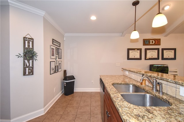 kitchen with pendant lighting, ornamental molding, sink, and light stone counters