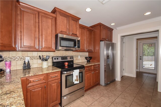 kitchen with light tile patterned floors, backsplash, stainless steel appliances, light stone counters, and ornamental molding