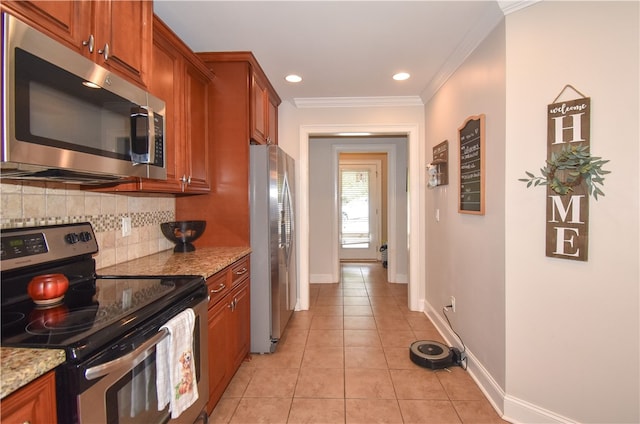 kitchen featuring light tile patterned flooring, appliances with stainless steel finishes, tasteful backsplash, crown molding, and light stone countertops