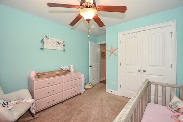 carpeted bedroom with ceiling fan and a closet