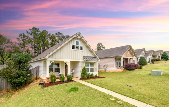 craftsman-style home with a yard and covered porch