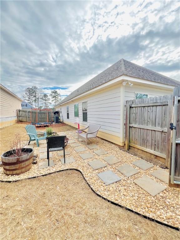 exterior space featuring a fire pit, a patio area, and a trampoline