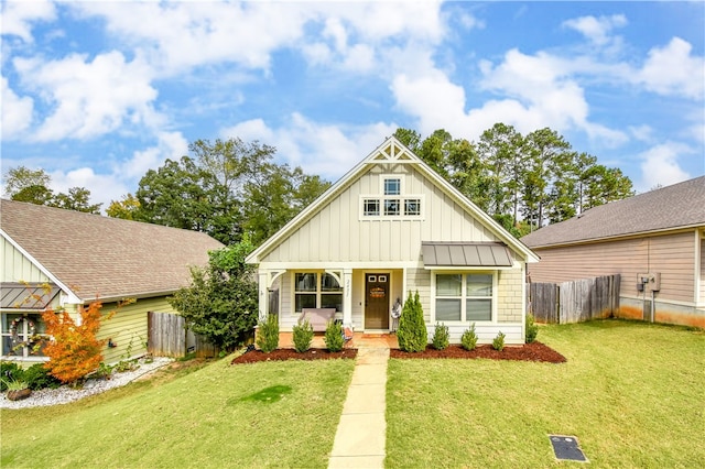 view of front of home with a front yard and a porch