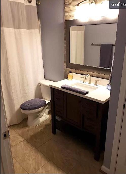 447 W Longleaf Dr Unit 101, Auburn, AL 36832 - bathroom with vanity, tile patterned floors, and curtained shower