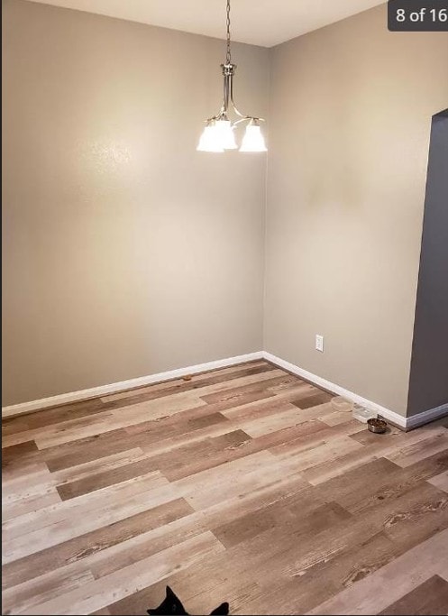 447 W Longleaf Dr Unit 101, Auburn, AL 36832 - empty room with wood finished floors and baseboards
