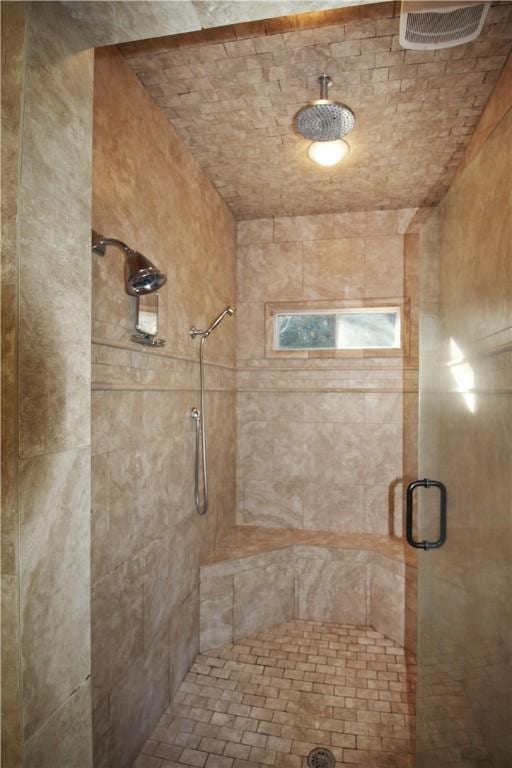 bathroom with a shower with door