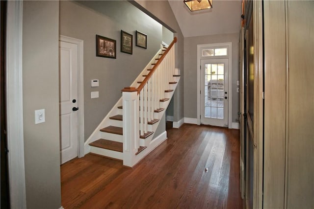 entrance foyer with dark wood-type flooring and lofted ceiling