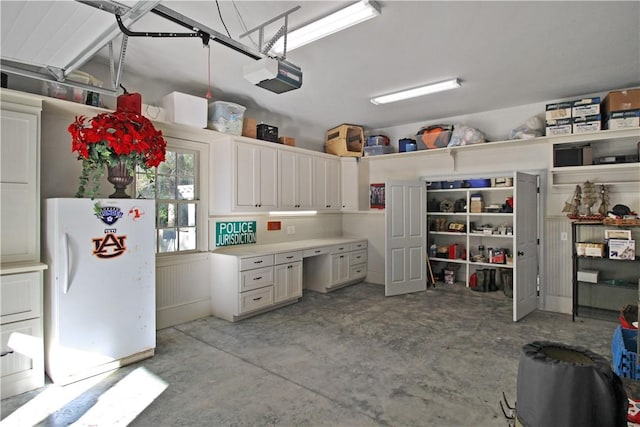 interior space with white fridge and white cabinetry