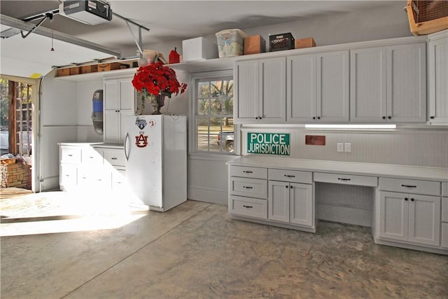 kitchen with white fridge and white cabinetry