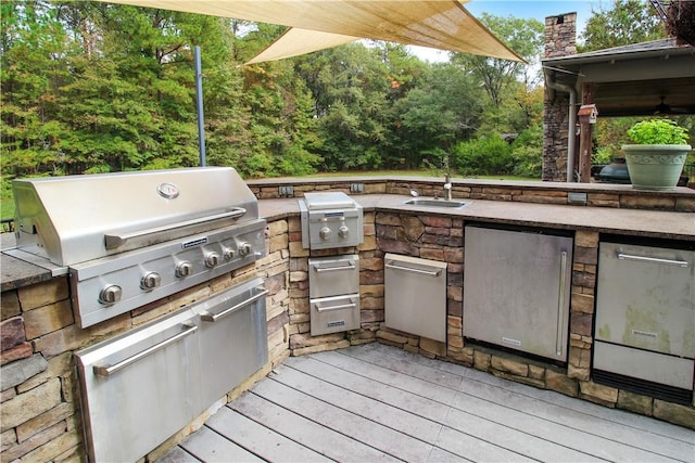 view of patio featuring area for grilling and sink