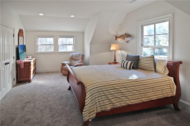 bedroom featuring a closet, carpet, and lofted ceiling