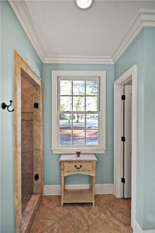 interior space with a tile shower, tile patterned flooring, and ornamental molding