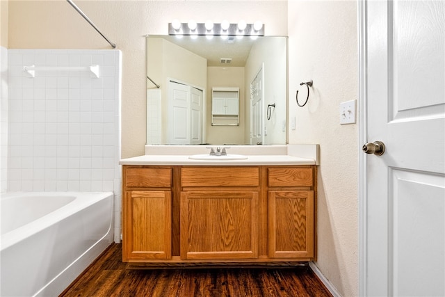 447 W Longleaf Dr Unit 1007, Auburn, AL 36832 - bathroom with vanity, wood finished floors, and washtub / shower combination