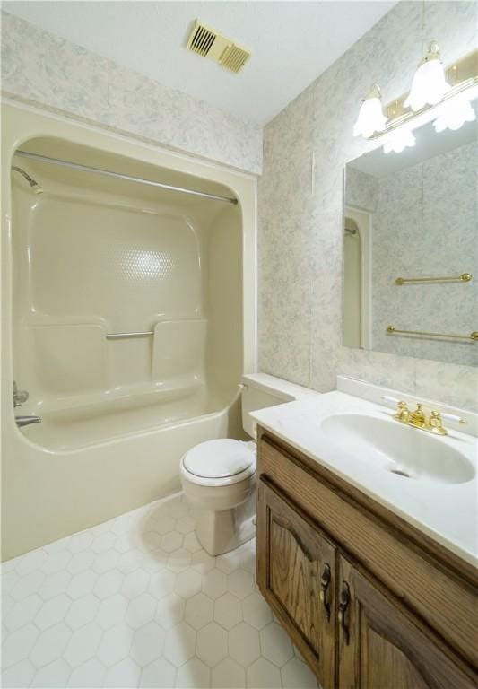 full bathroom with shower / bathing tub combination, tile patterned flooring, vanity, and toilet