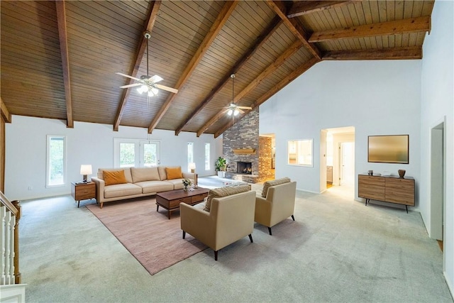 living room with wooden ceiling, a stone fireplace, beamed ceiling, high vaulted ceiling, and light colored carpet