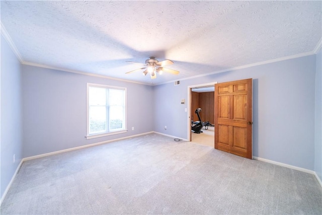 unfurnished bedroom featuring crown molding, light colored carpet, and a textured ceiling