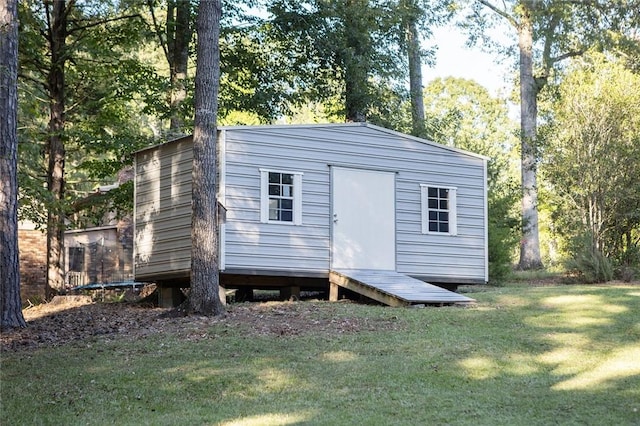 view of outdoor structure featuring a lawn