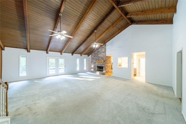 unfurnished living room featuring beam ceiling, ceiling fan, wooden ceiling, high vaulted ceiling, and a fireplace