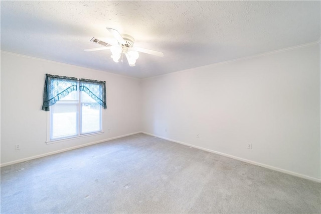 unfurnished room with ceiling fan, carpet floors, and a textured ceiling