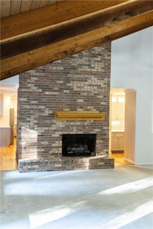 unfurnished living room with beam ceiling, a fireplace, high vaulted ceiling, and wooden ceiling