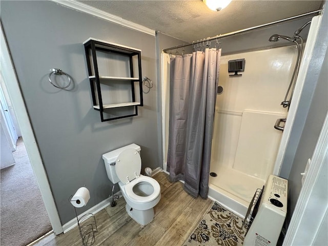 4380 County Road 62, Lafayette, AL 36862 - bathroom featuring wood finished floors, toilet, a stall shower, and a textured ceiling