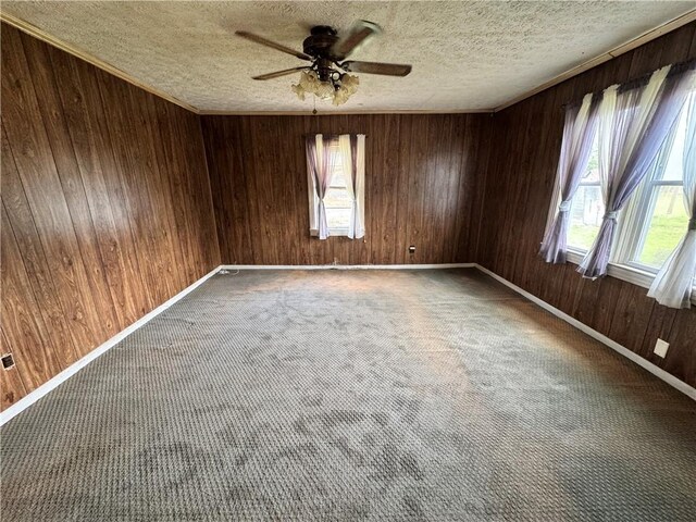 4380 County Road 62, Lafayette, AL 36862 - carpeted spare room with baseboards, a textured ceiling, wooden walls, and ceiling fan