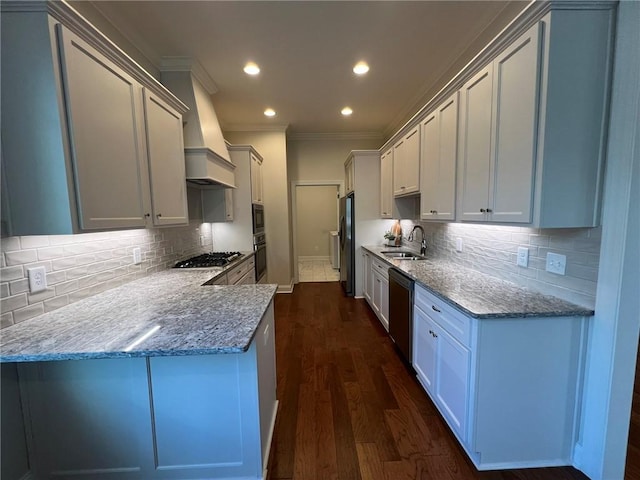 kitchen with a sink, stainless steel appliances, dark wood finished floors, tasteful backsplash, and ornamental molding