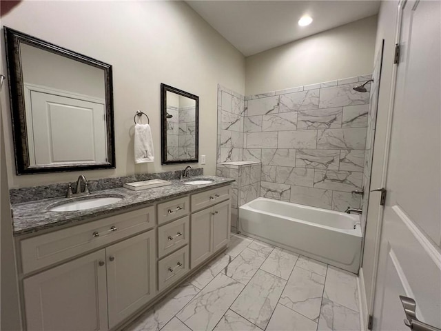 full bath featuring double vanity, bathing tub / shower combination, marble finish floor, and a sink