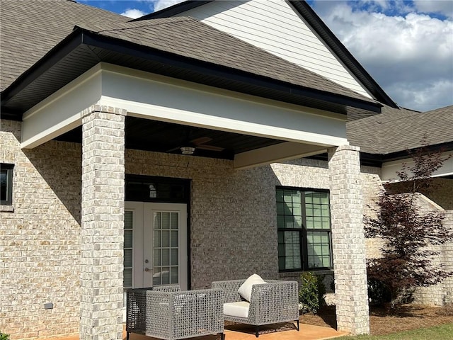 exterior space featuring a ceiling fan, roof with shingles, and french doors