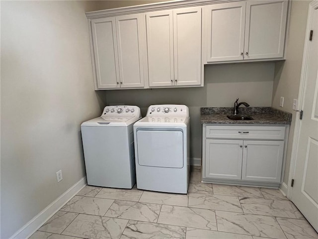 laundry room featuring baseboards, marble finish floor, a sink, washer and clothes dryer, and cabinet space