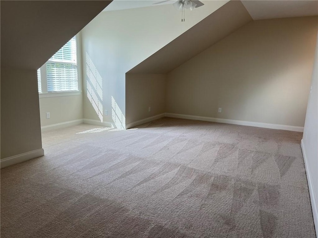additional living space featuring ceiling fan, lofted ceiling, carpet, and baseboards