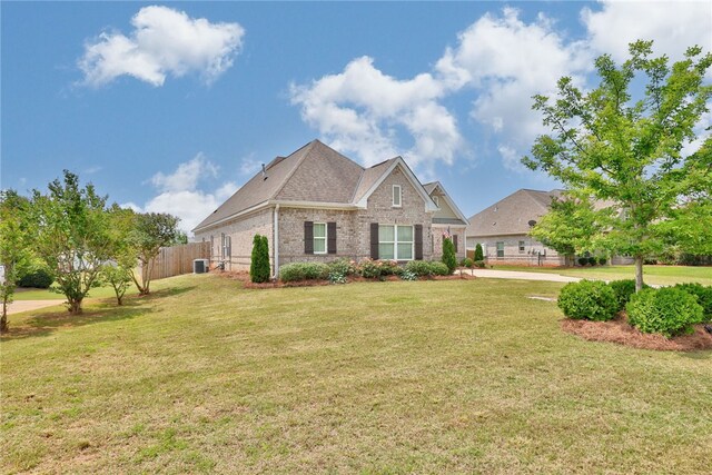 914 E Towne Lake Cir, Opelika, AL 36804 - view of front of home featuring brick siding, central air condition unit, and roof with shingles
