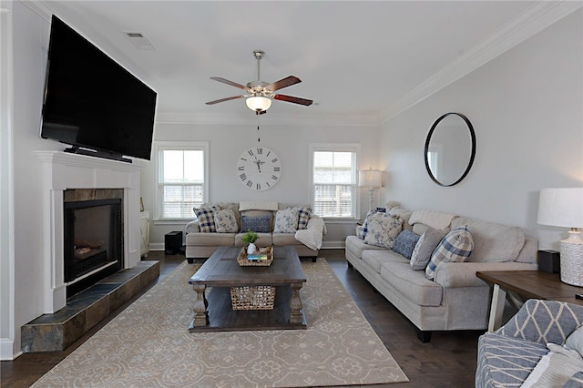 914 E Towne Lake Cir, Opelika, AL 36804 - living room with plenty of natural light, ceiling fan, a tiled fireplace, crown molding, and dark wood-type flooring
