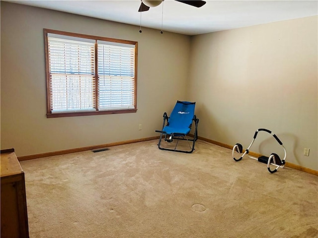 unfurnished room featuring a ceiling fan, light carpet, visible vents, and baseboards